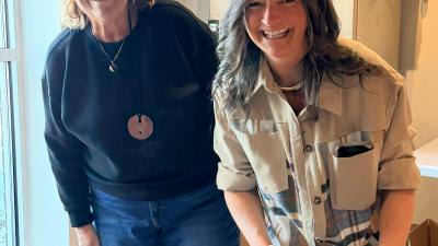 United Way Board Members Dee Custar(L) and Misty King(R) help fill boxes for those in need